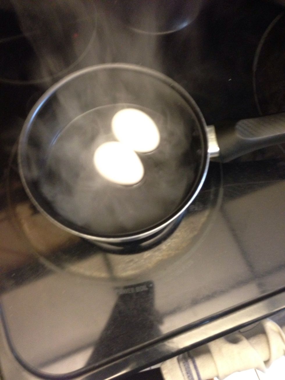 Add eggs to the water. You are essentially steaming the eggs, not boiling them. They should not be submerged in the water.