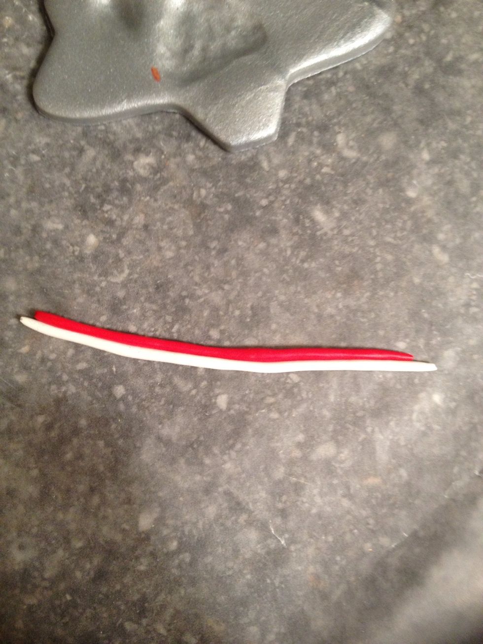 Add embellishments. I added a candy cane. To make one, use red and white clay rolled into 2 thin ropes. Place them next to each other.