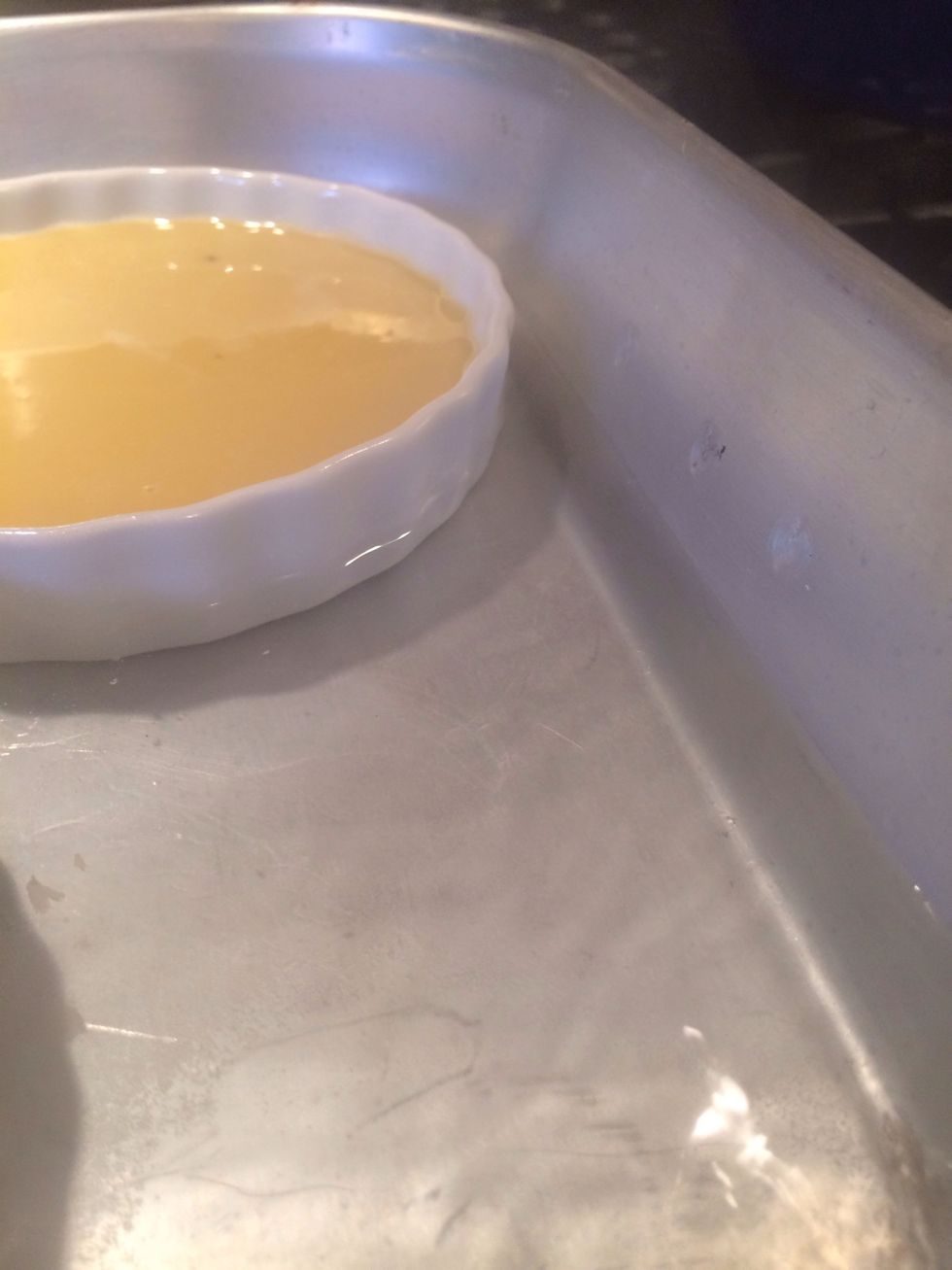 Add enough water to equal about 1/2 the hight of the custard dish.
