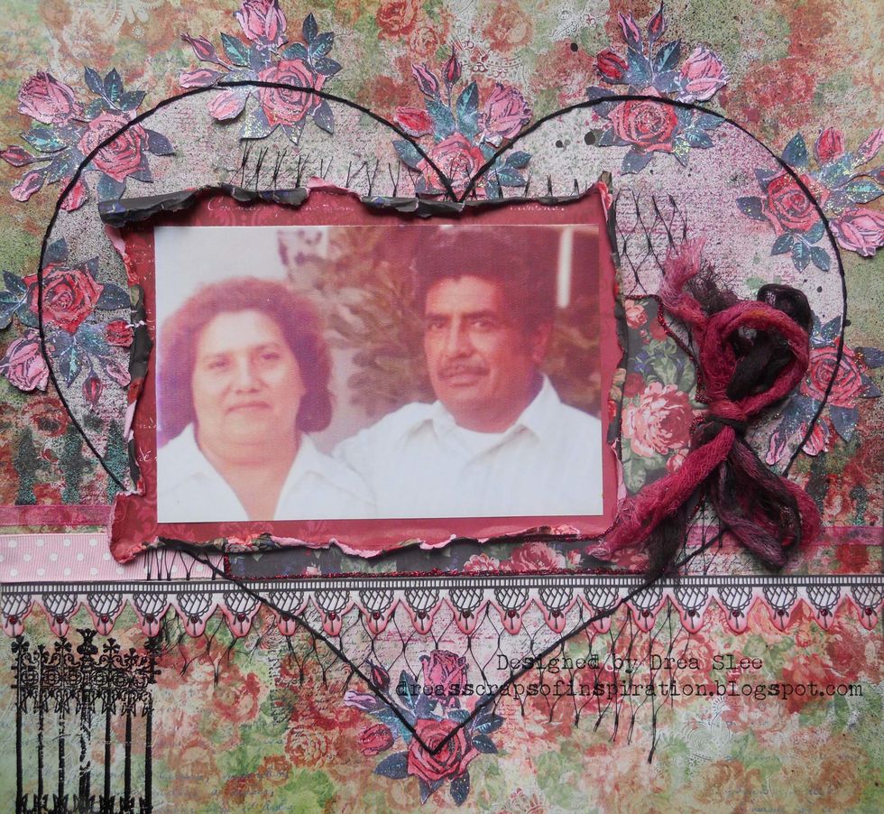 Add Eucalyptus Stickles to the leaves and Cotton Candy Stickles to the flowers. Add some black stitching around the heart. Use black embossing powder to stamp the fence in the lower left corner.