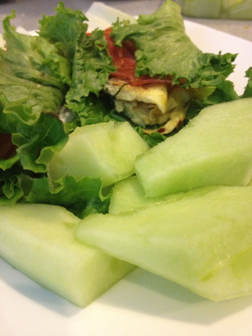 Add few melon slices to the side and your healthy paleo-friendly egg-salami green wrap is ready