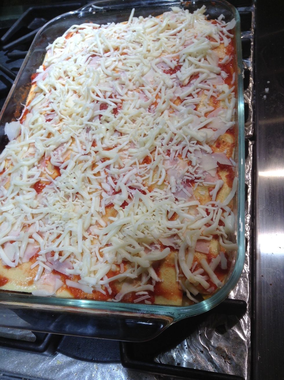 Add final layer of pasta, remaining sauce, sprinkle with shaved parmesan, mozzarella and asiago. Bake at 325F,