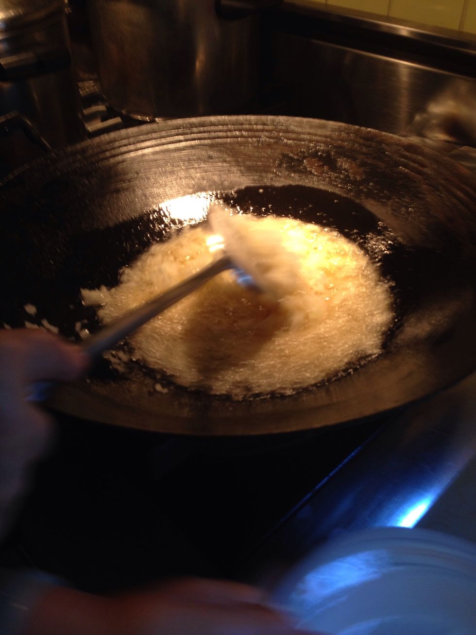 Add finely chopped onions to 2 cups of oil in wok on high heat - stir occasionly. Add chopped garlic after sweating onions.