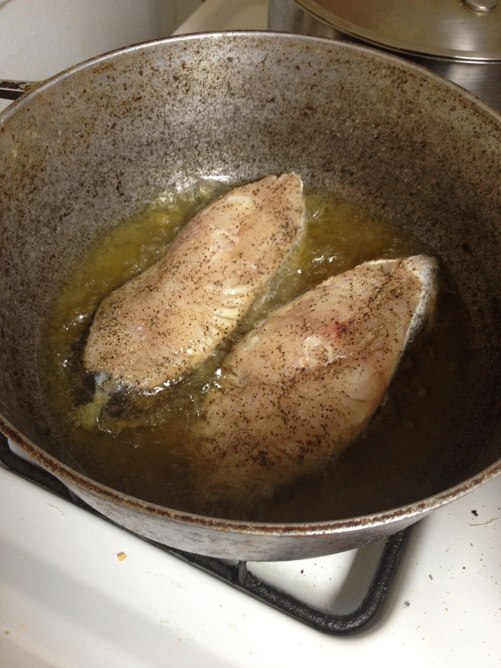 Add fish to hot oil and fry both sides under medium-high heat until brown.
