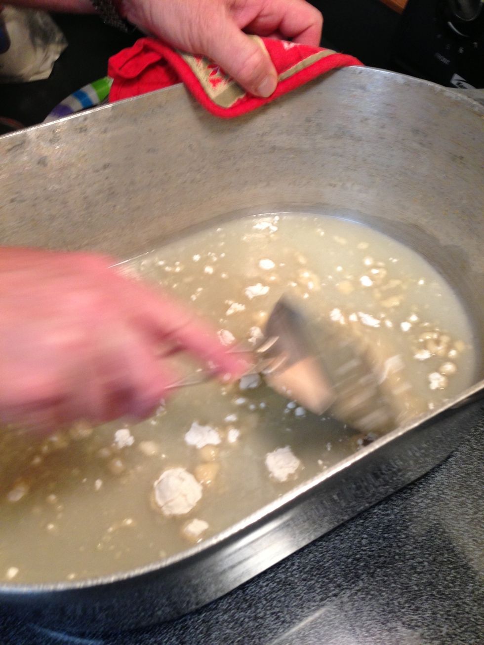Add flour a half a cup at a time, stirring with a metal, flat bottom spoon. You should see small bubbling.