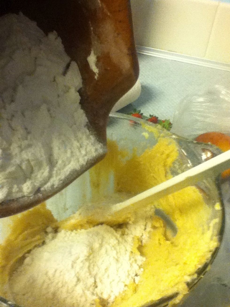 Add flour. NOT ALL AT ONCE! And stir in. Then add some more, and stir.. Continue till all flour us gone.