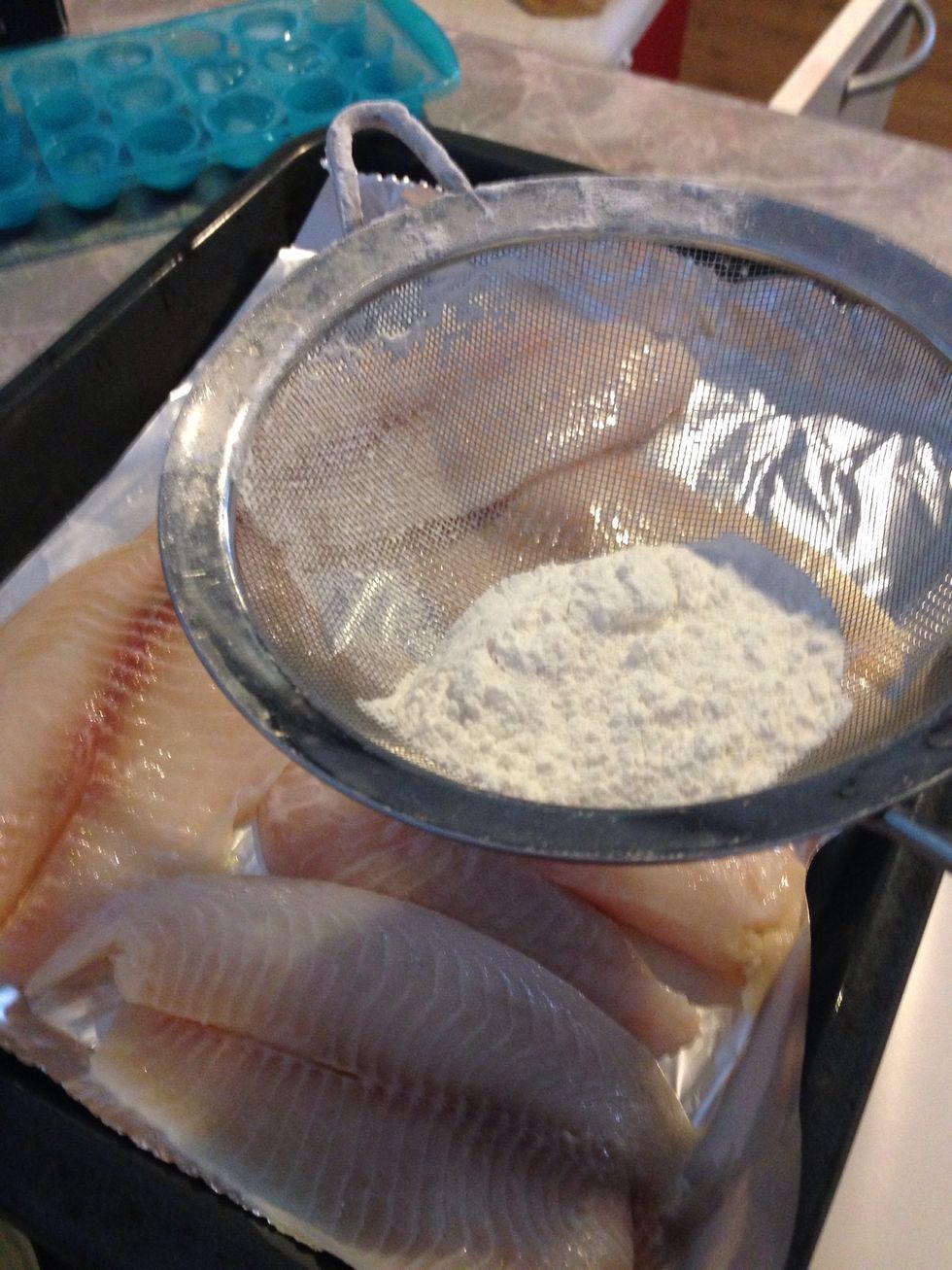 Add flour on top of the tilapia/both sides