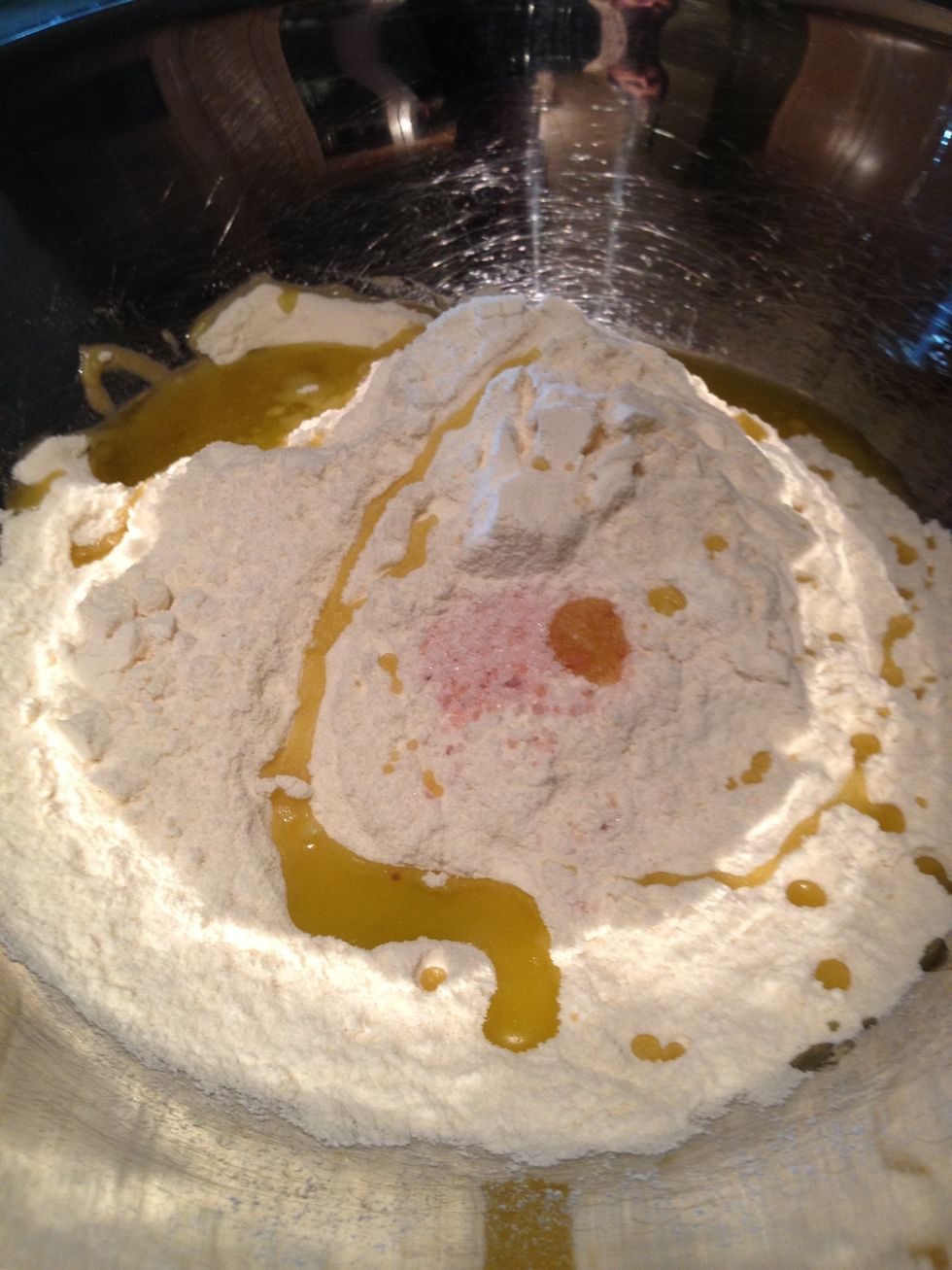 Add flour, salt & olive oil to a bowl. You don't have to use Himalayan Pink salt - any salt will do. You can also use other kinds of flour -- but semolina and extra fine flour are the tastiest!