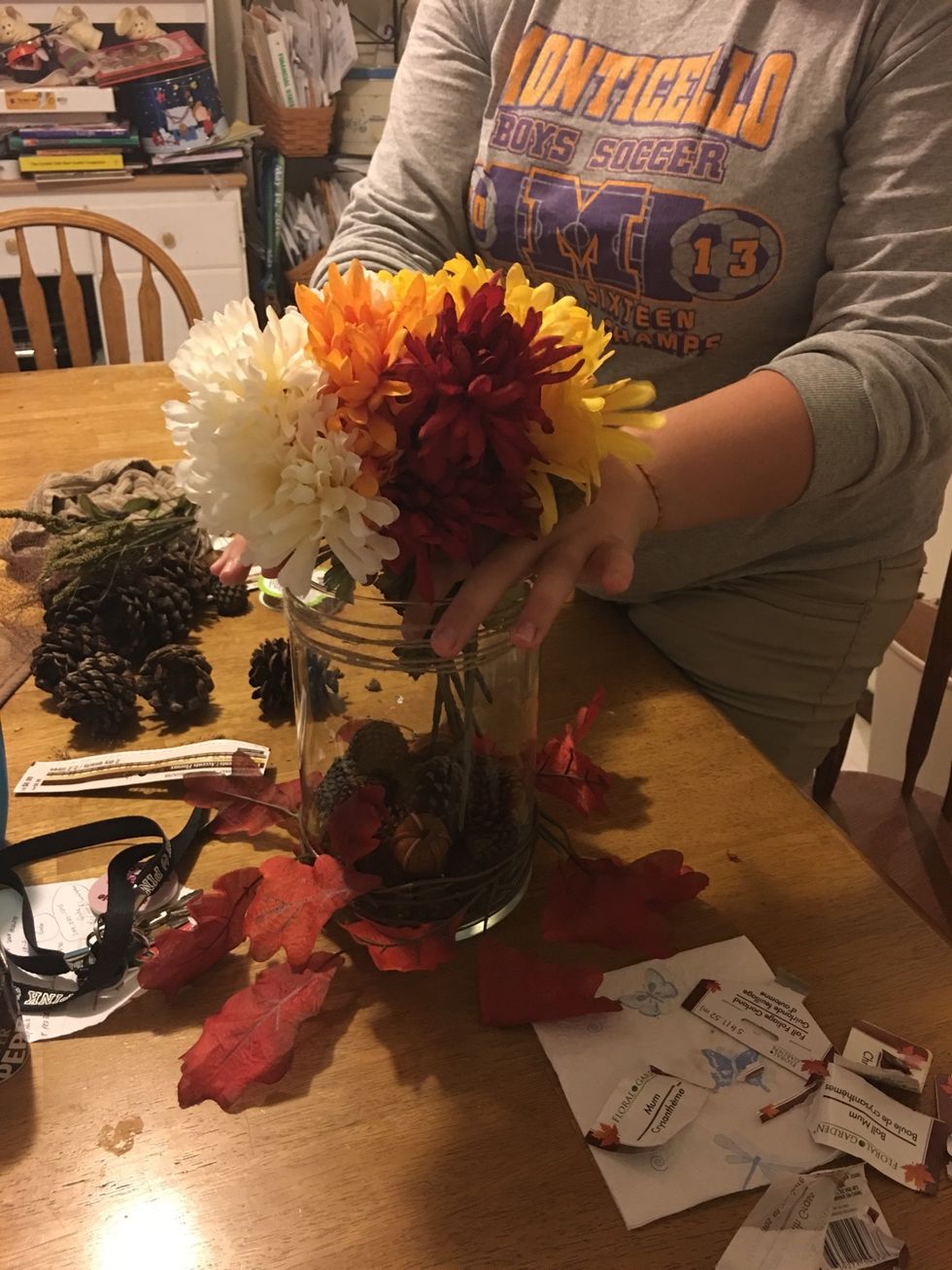 Add flower arrangement into vase.