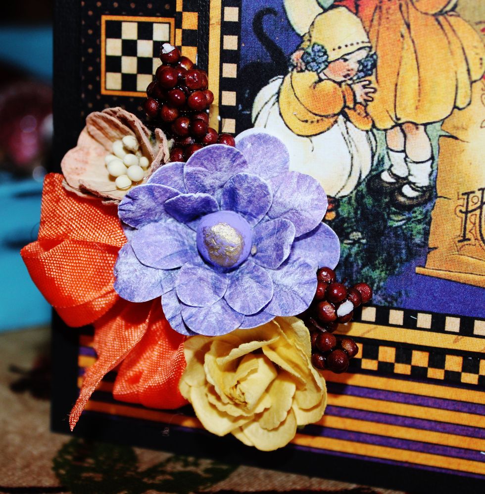 Add flowers, berries and ribbon to front of card.