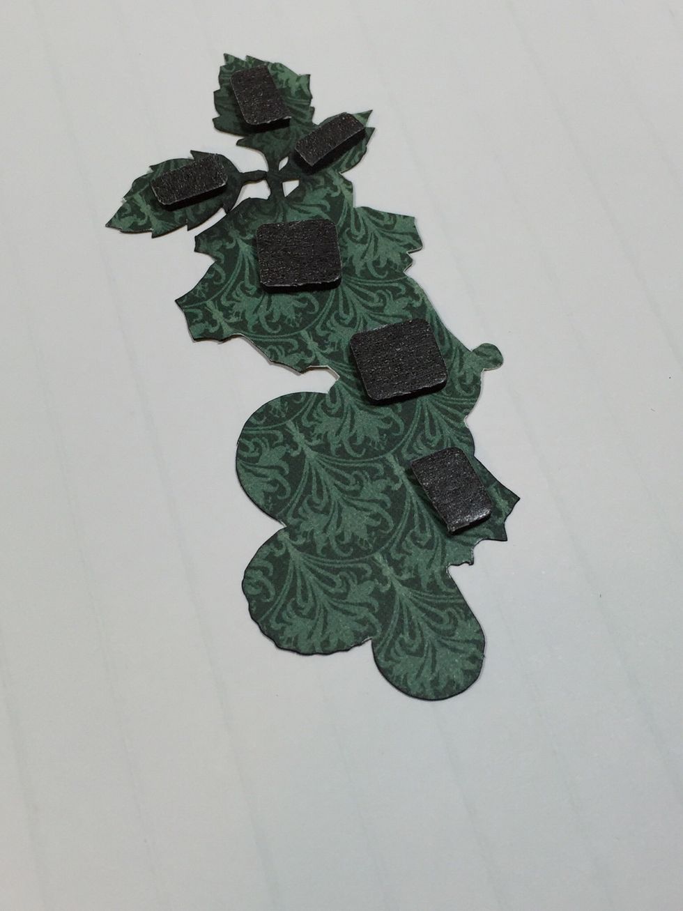 Add foam tape to the back of the fussy cut flower piece, only to the areas shown. Then add adhesive to the other areas.