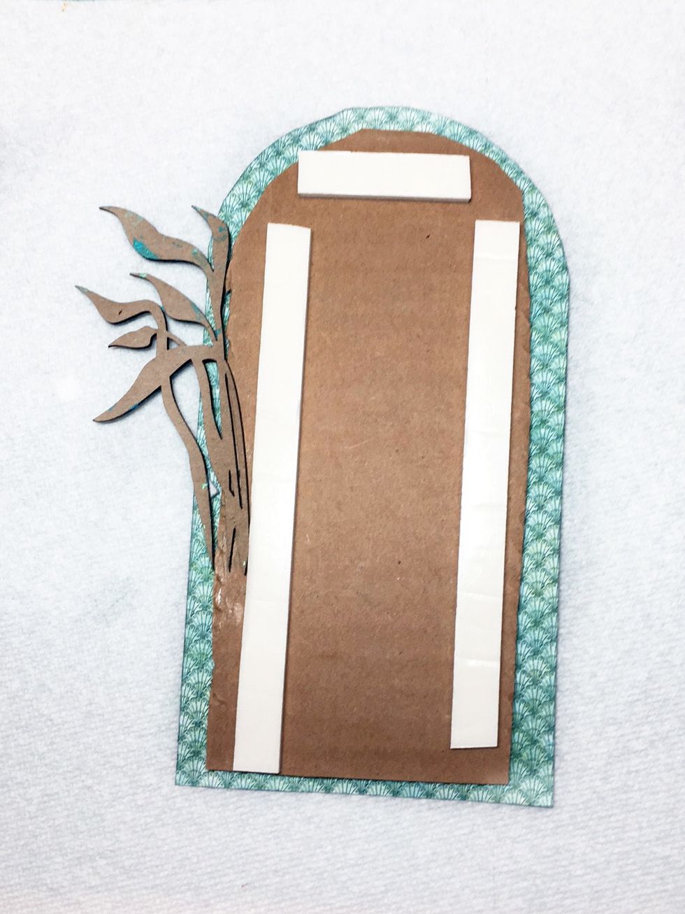 Add foam tape to the back to pop up another layer. Glue a piece of seaweed as shown.