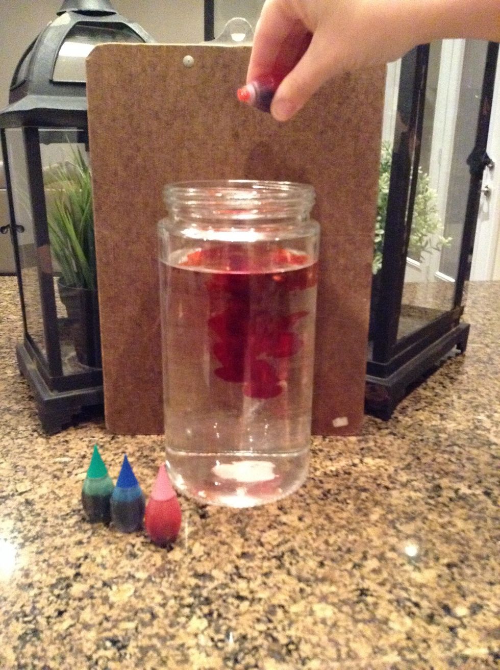 Add food colouring to the jar until it meets your liking