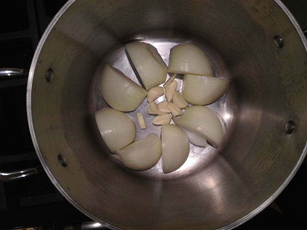 Add four cloves of garlic, halved.