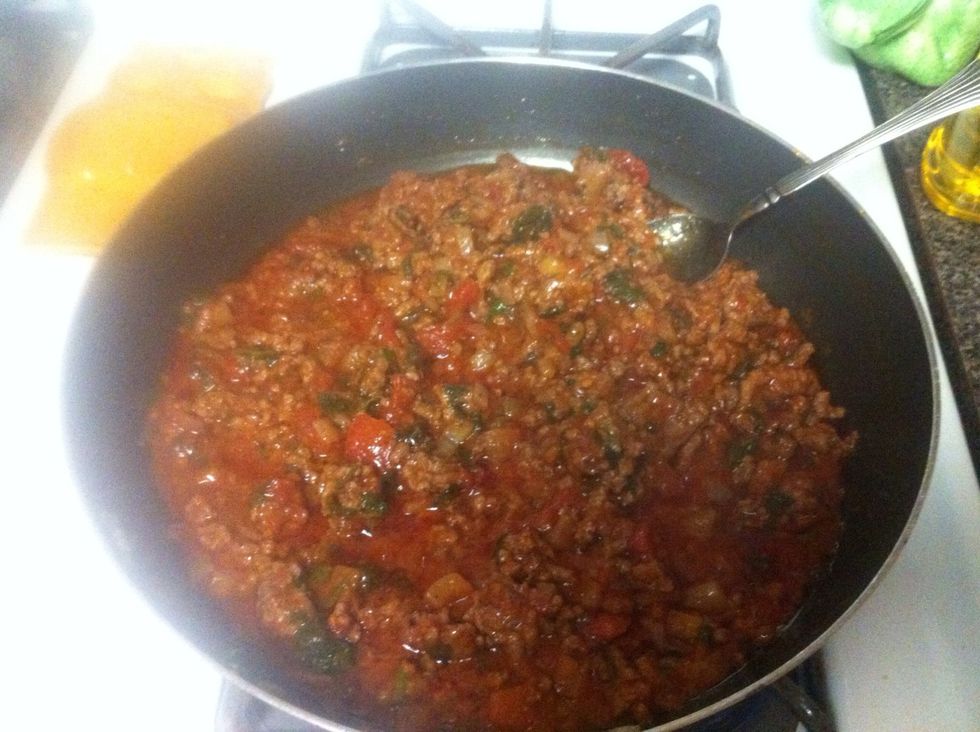 Add four crushed San Marzano tomatoes, mix well and let simmer over low heat.