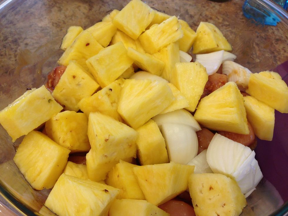 Add fresh cubed pineapple and the onions to the bowl with the chicken. Stir everything together.