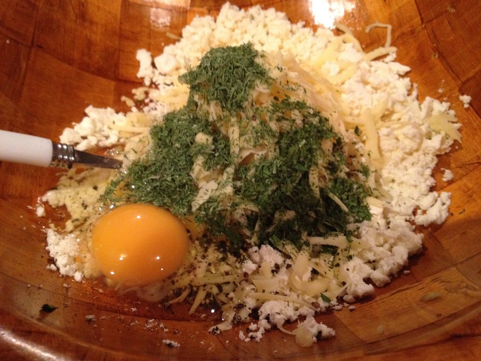 Add freshly ground pepper, herbs, eggs.