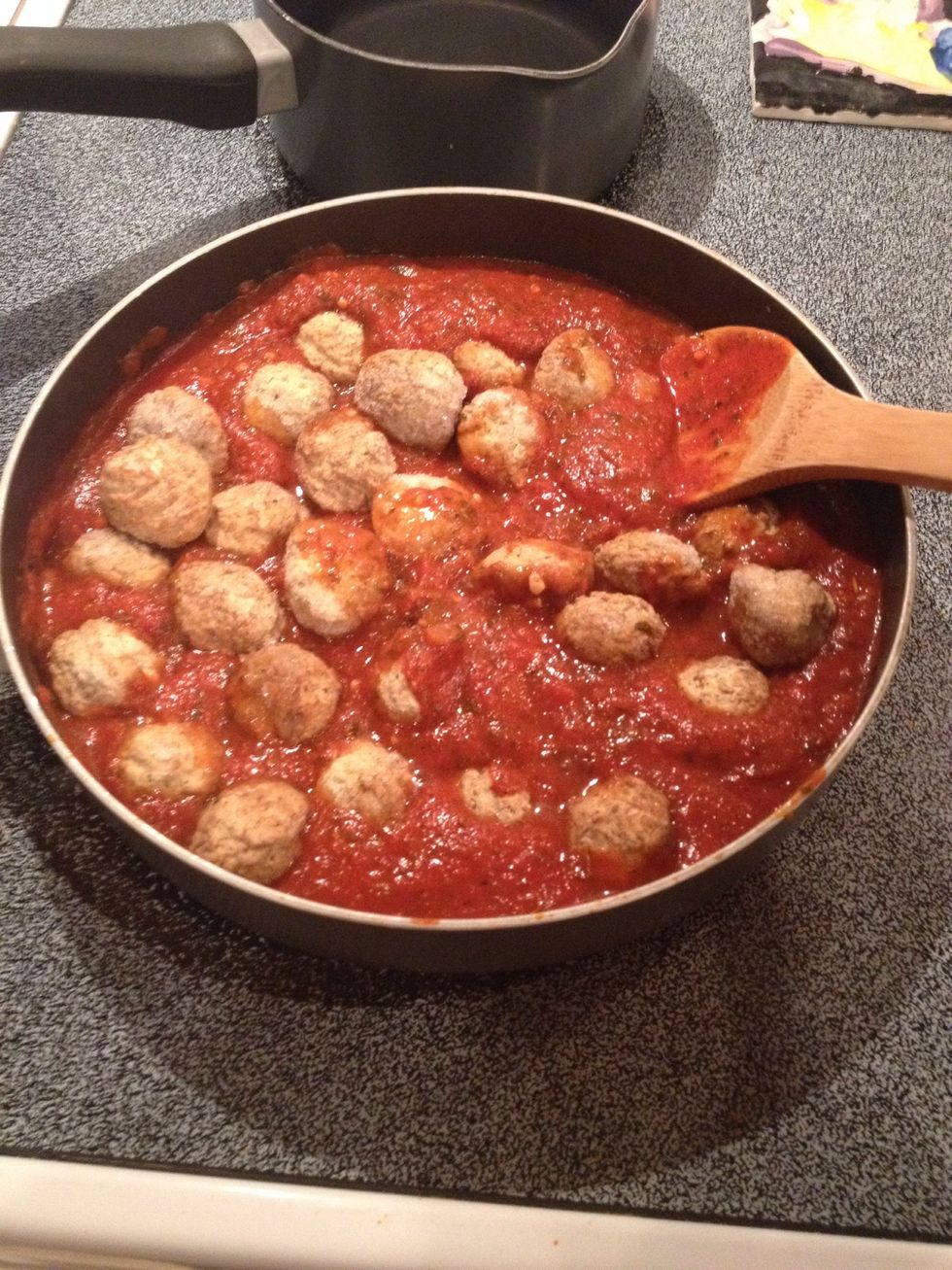 Add frozen meatballs to sauce.