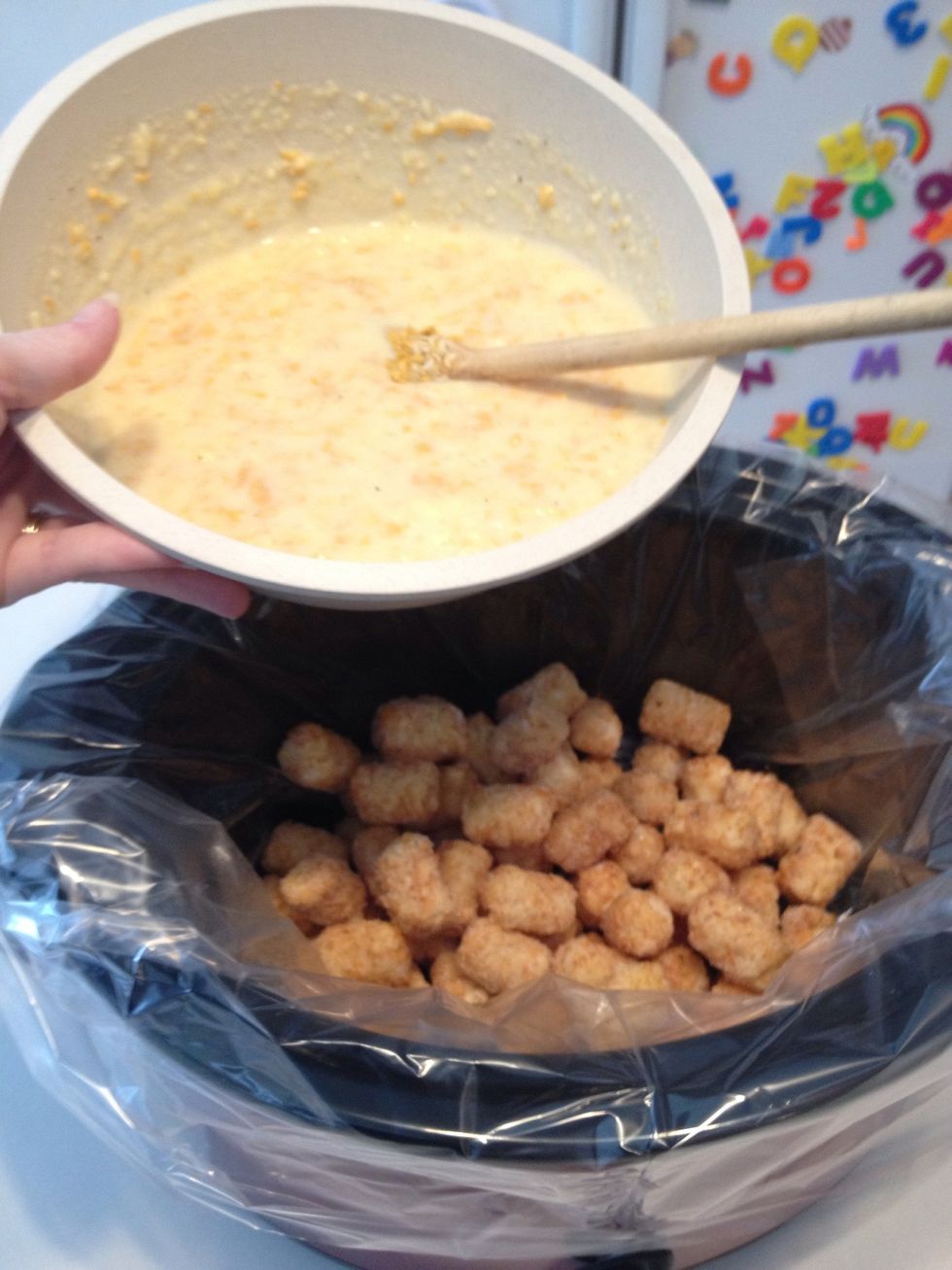 Add frozen tater tots to crockpot. Pour sauce on top of tater tots.
