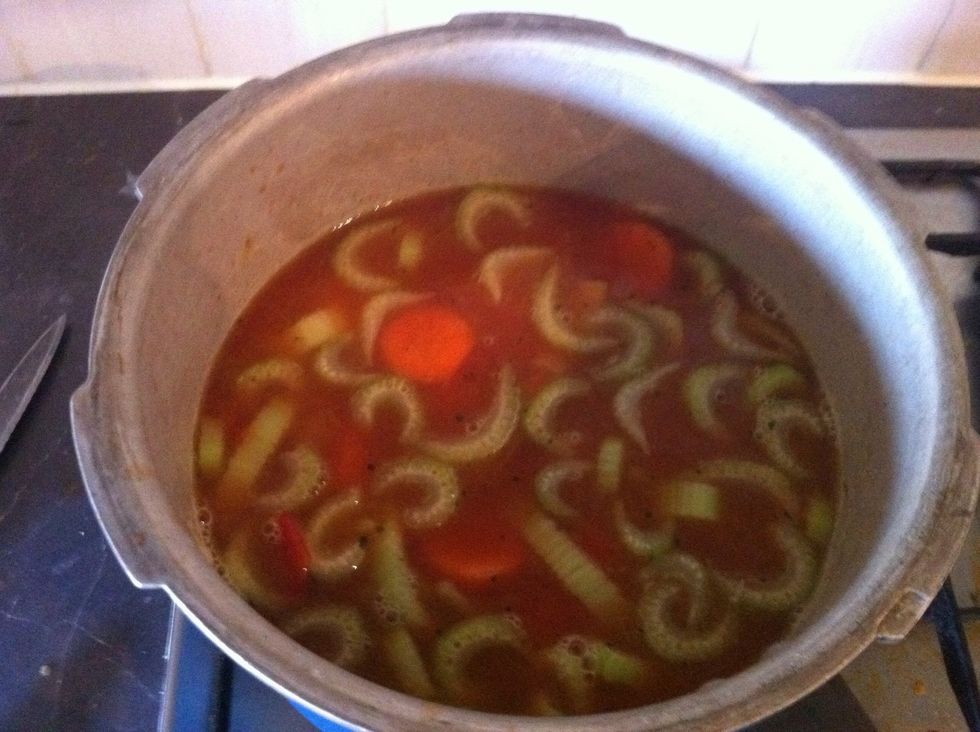 Add full tin of chopped tomatoes, stir and bring to boil.