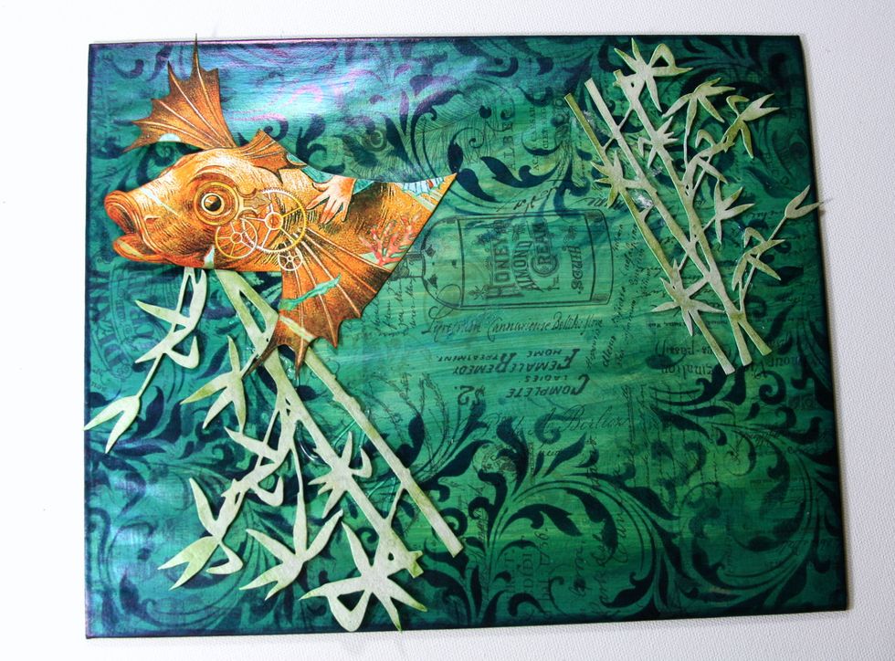 Add fussy cut fish image from Voyage Beneath the Sea using adhesive foam spacers.