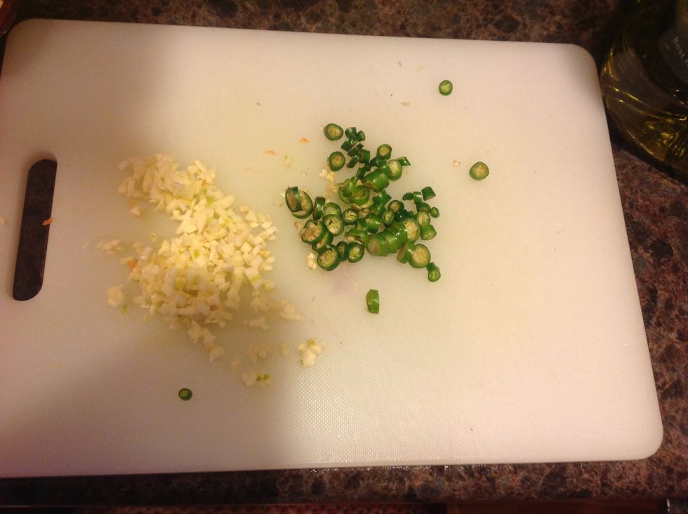 Add garlic and chiles. I like things very spicy, so I'm using about 4 Thai chiles, and these particular chiles were super hot! Use any peppers you like for this and adjust for spice level preference.