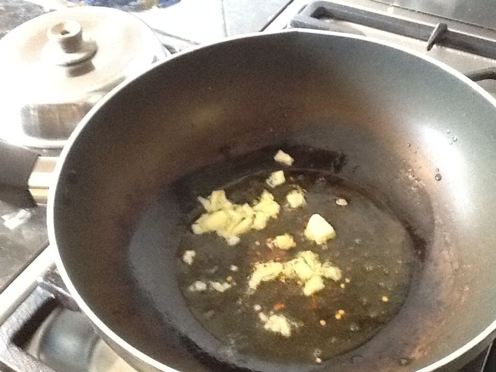 Add garlic and chilli flakes to heated oil and fry for 30 seconds - 1 min, careful not to burn the garlic.