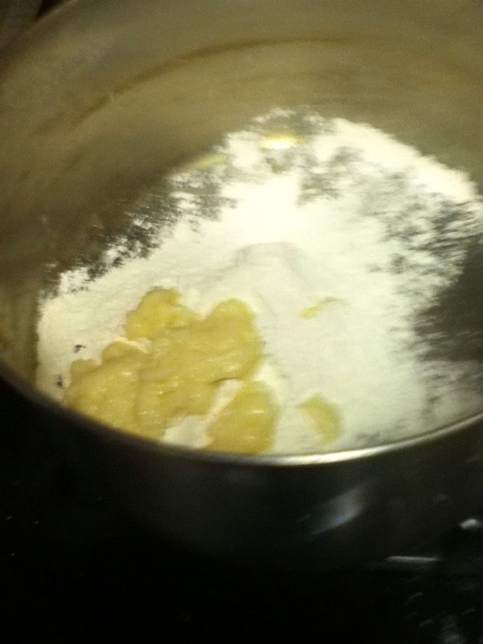 Add garlic and flour. Cook for 1 minute, whisking.