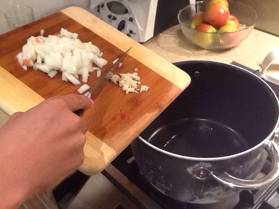 Add garlic and onion into the pot, saut\u00e9 until onion softens ( 2-3 minutes)