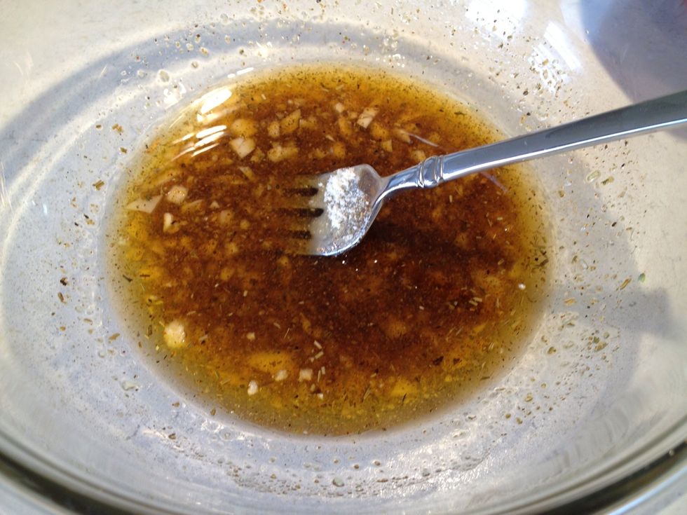 Add garlic, chili powder, Parmesan cheese, and chicken seasoning to oil. Stir well.
