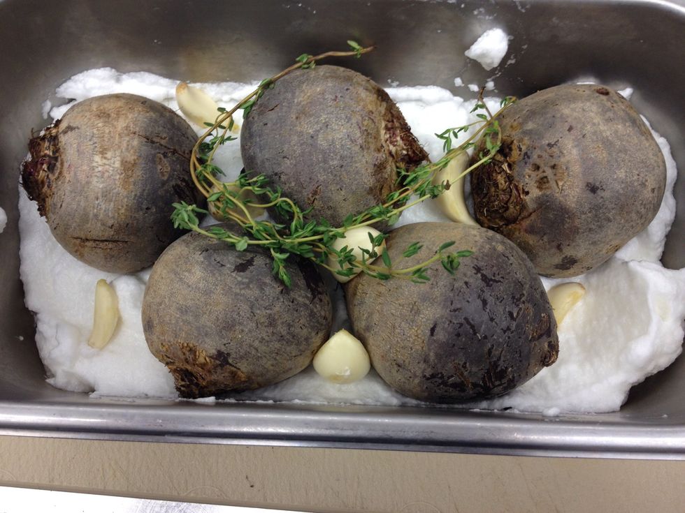 Add garlic cloves and thyme sprigs.