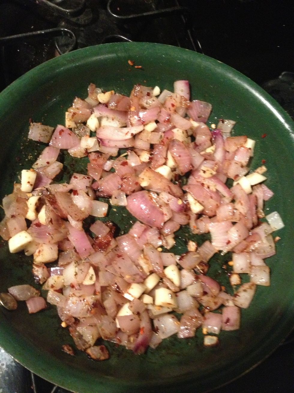 Add garlic, red pepper flakes and Italian seasoning to onions. Cook for about 1 minute.