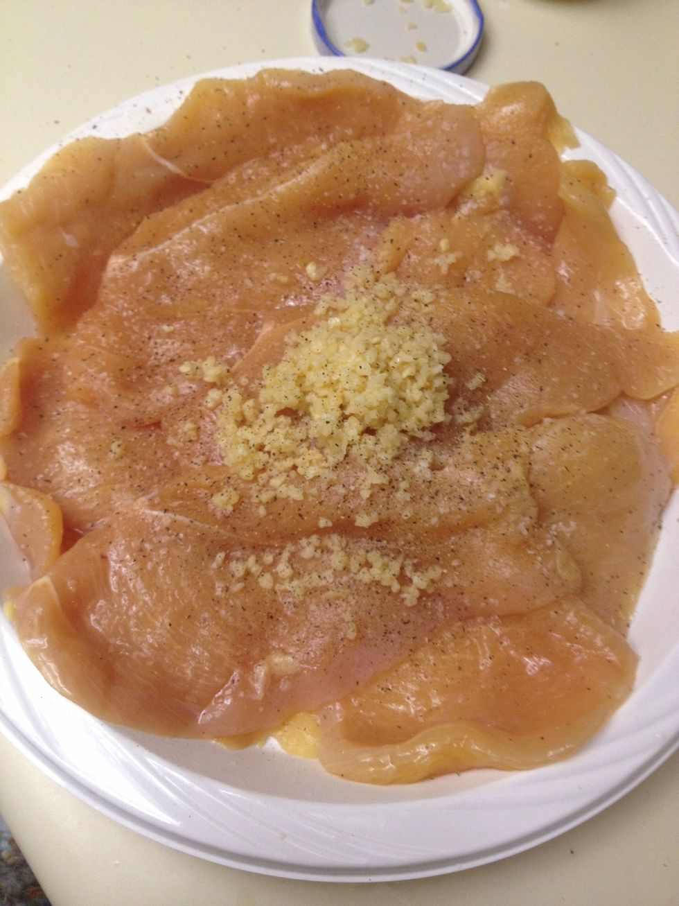Add garlic, salt and pepper to your chicken breasts.