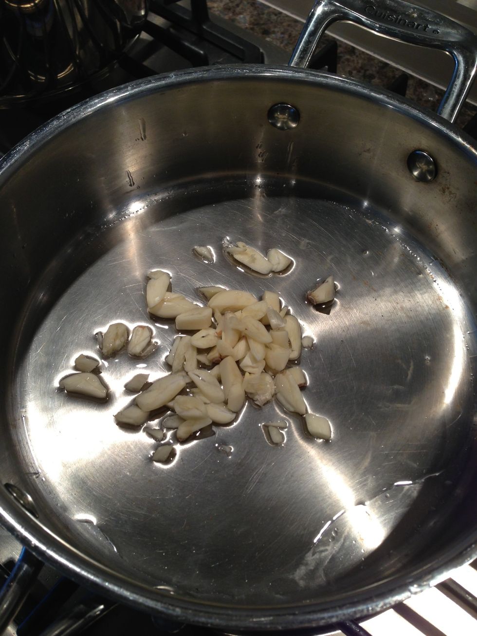 Add garlic while you heat up 4 tbsp of oil. Don't do this when the oil is hot or the garlic will burn.