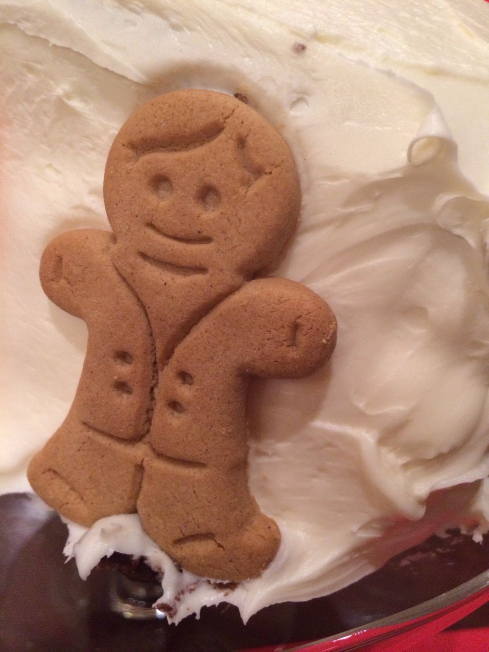 Add gingerbread cookies to the sides of the cake, 2 on each side.