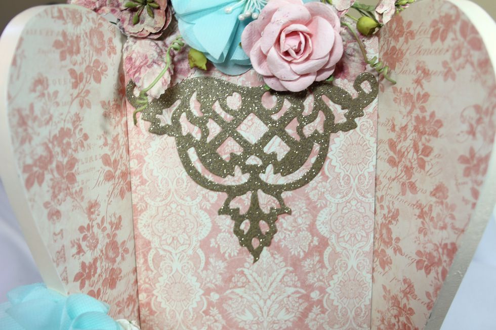 Add glittered die cut to the top portion of the chair just below the flowers.