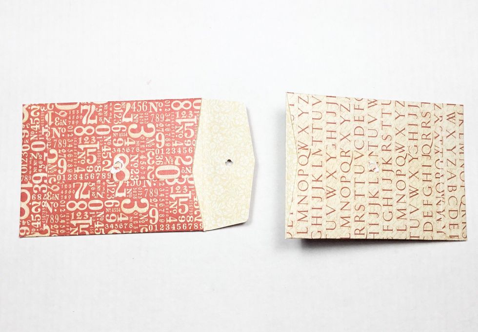 Add glue and insert tab of red envelope into cream envelope. Fold the cream envelope tab back as shown in next step, this is the glued and inserted into next envelope.