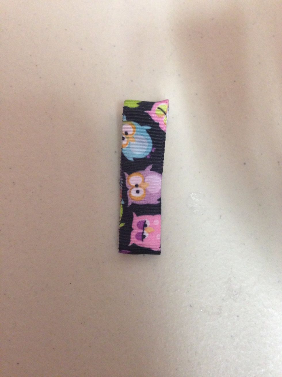 Add glue on the top and pull the ribbon over