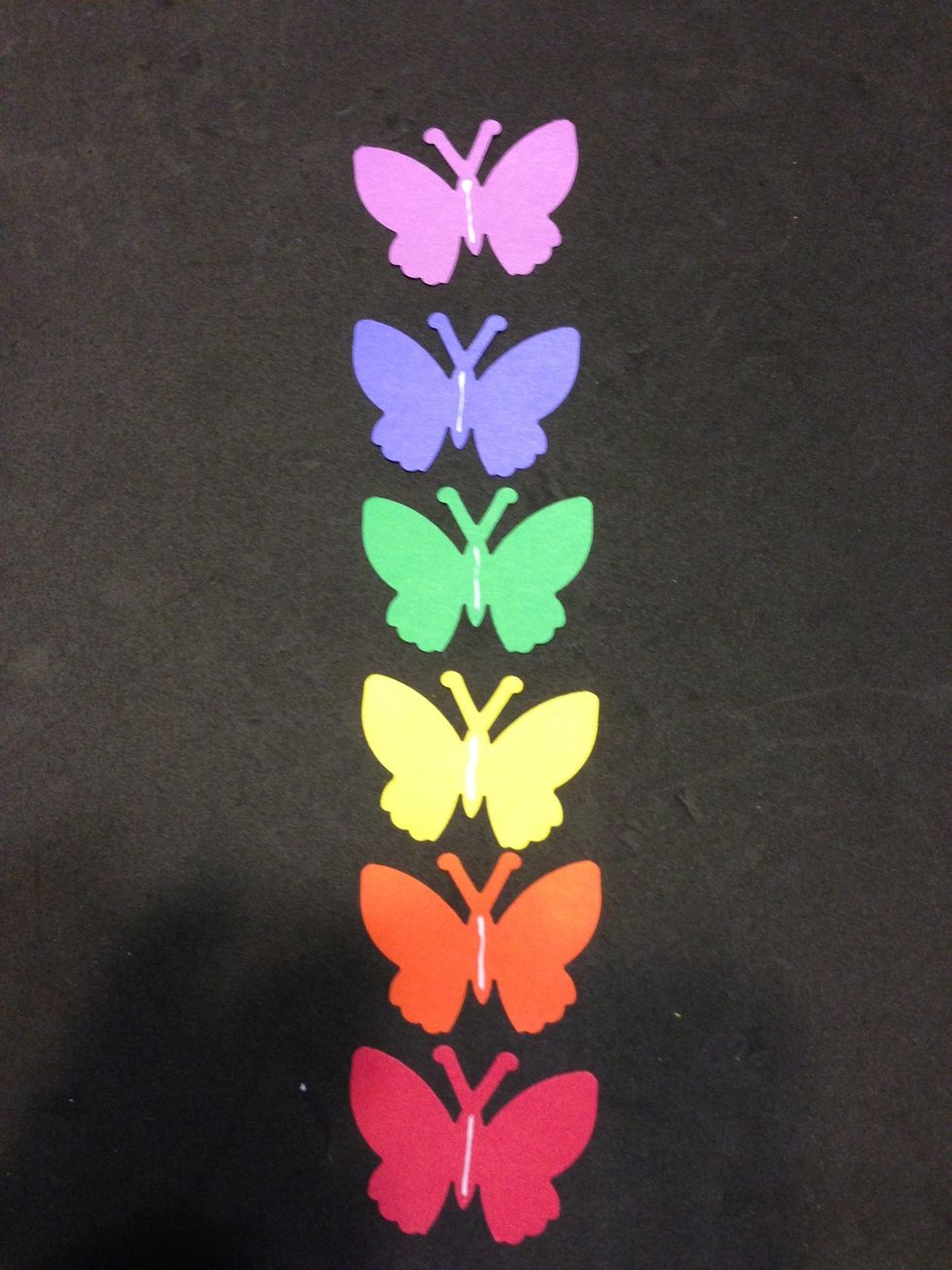 Add glue strip to all colored butterflies and stack placing white on top.