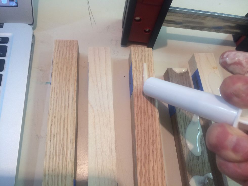 Add glue to all up facing surfaces except the last piece of wood on the right (piece H)