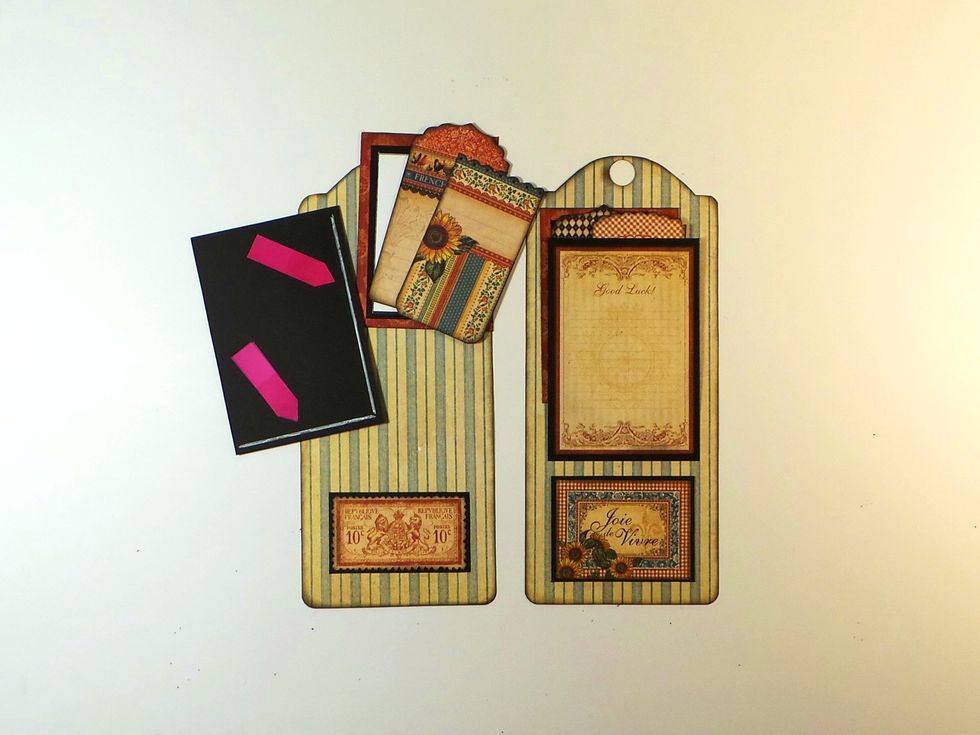 Add glue to one long edge & bottom (red arrows) of cut-apart to make pocket. Glue opposite long edge for other tag (1 opens left, the other right). Insert tags & photo mat. Add element under pocket.