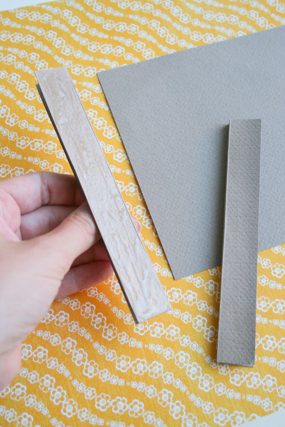 Add glue to one side of the paper strips