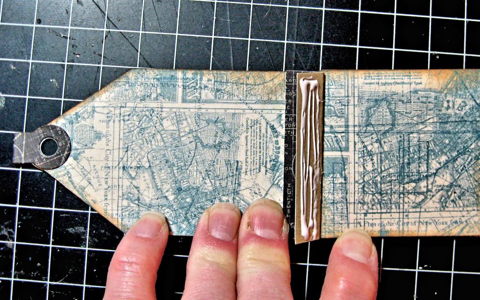 Add glue to right hand side of binding. Butt stitched inside pages flush against right hand side of the cover. Be sure bow is free. Glue down.