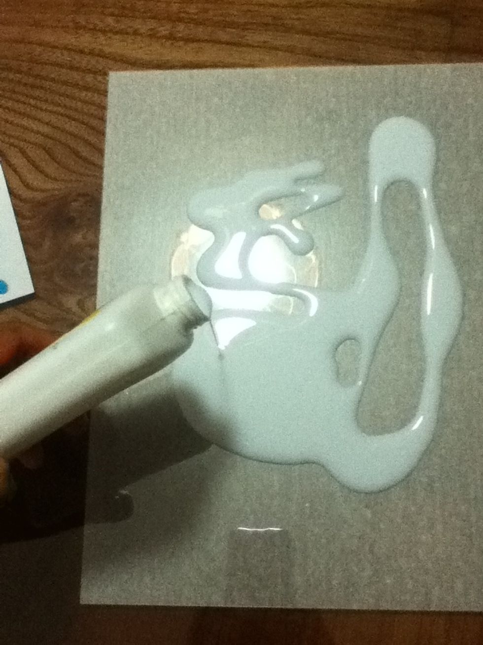 Add glue to the acetate sheet.