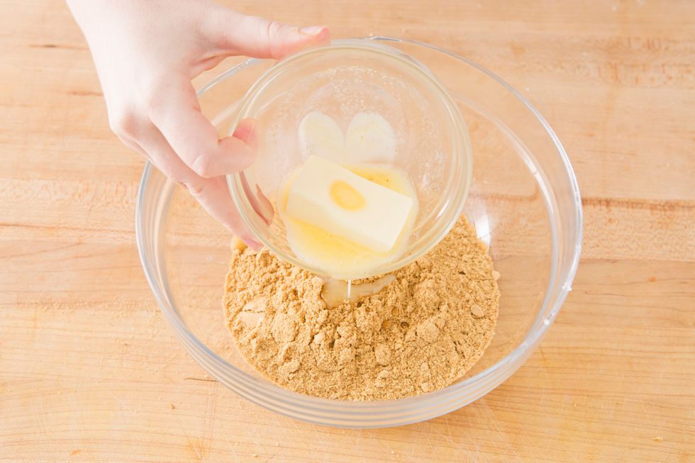 Add graham cracker crumbs to a large bowl and add melted butter.