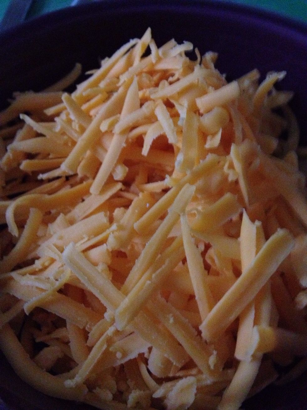 Add grated cheddar cheese to your sauce. Stir sauce then add grated monterrey jack cheese. Stir.