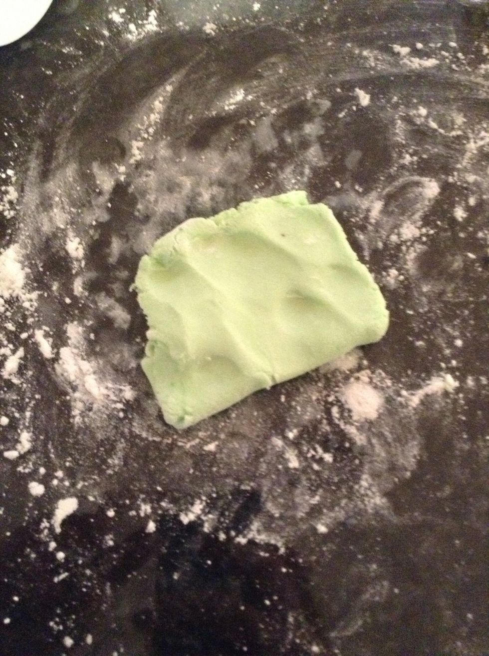 Add green food dye to another handful of moulding icing and mix in until you get a solid color you are happy with