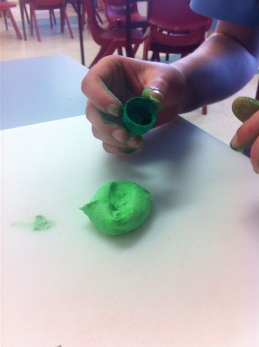 Add green food dye to the white fondant icing