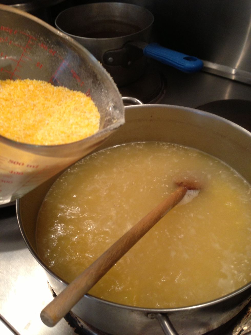 Add grits slowly to chicken broth and water and salt if you like