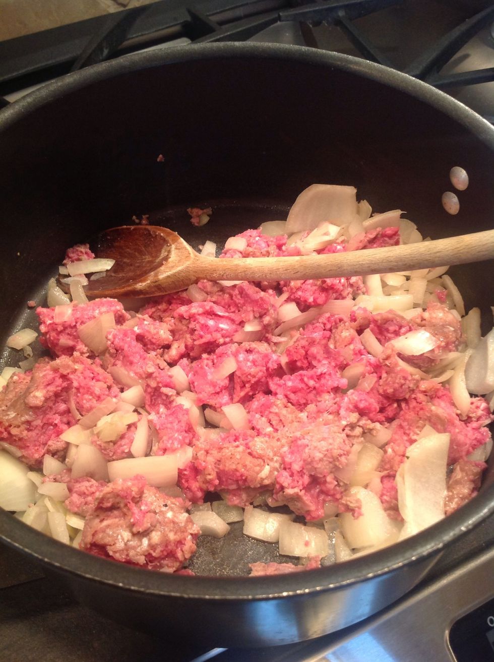 Add ground beef, salt, and pepper.